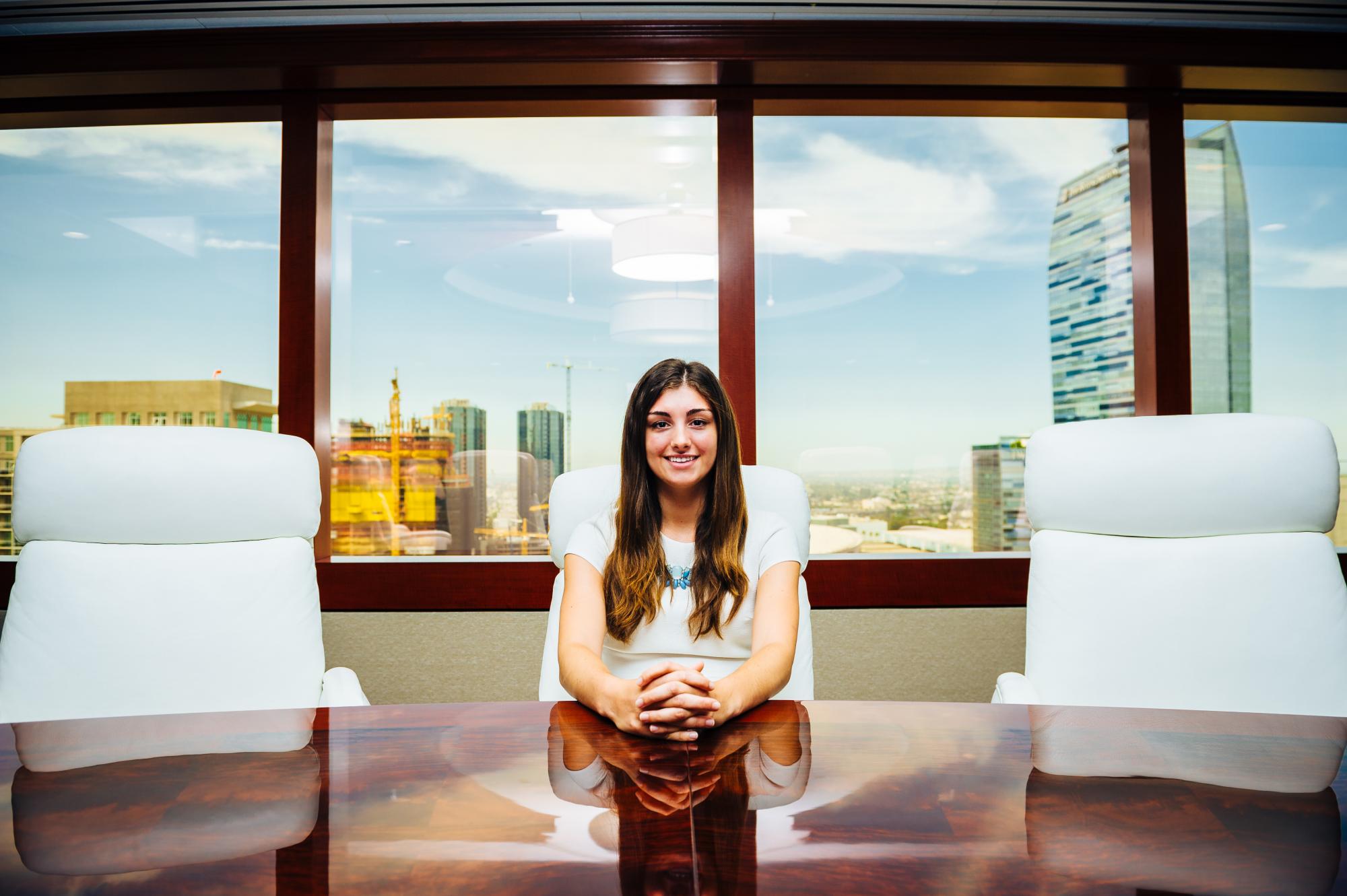 Picture of young woman at a boardroom table