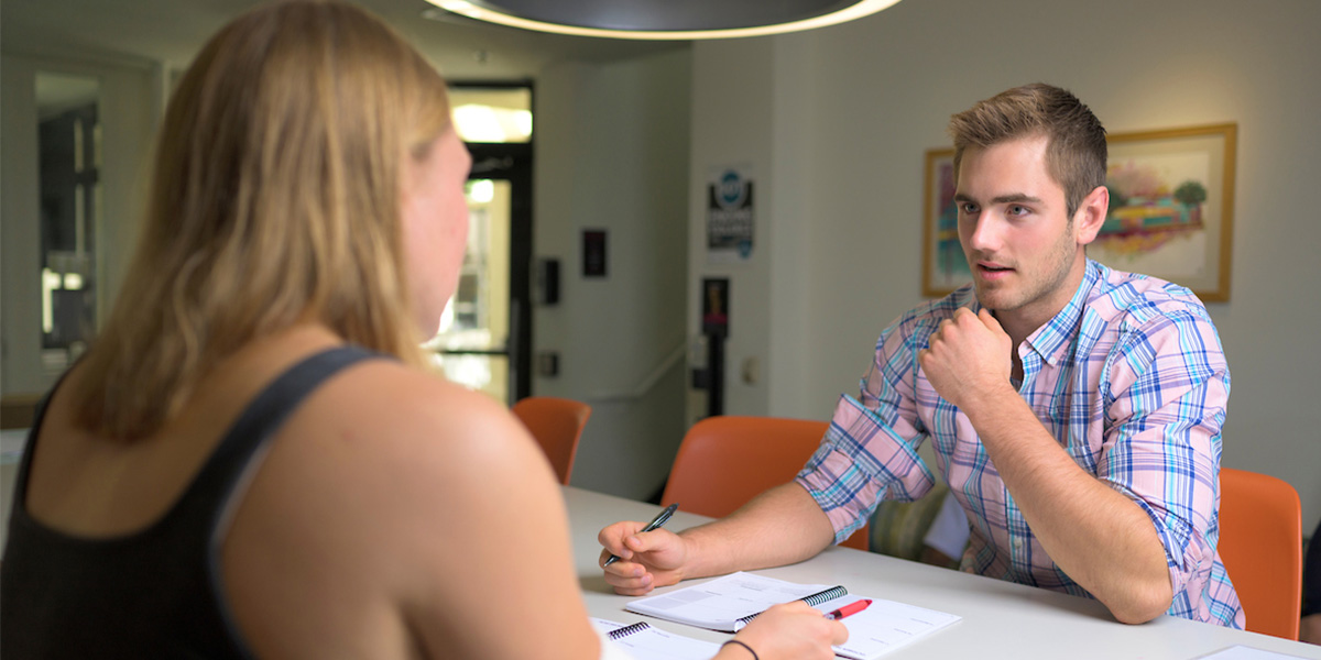 A Romero Success Coach working with a fellow student.