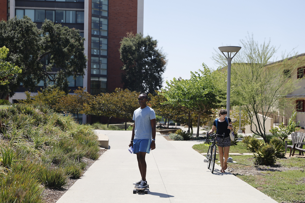 Tendai Nyamuronda '26 longboarding past Valach and Berger Halls during the first week of classes.