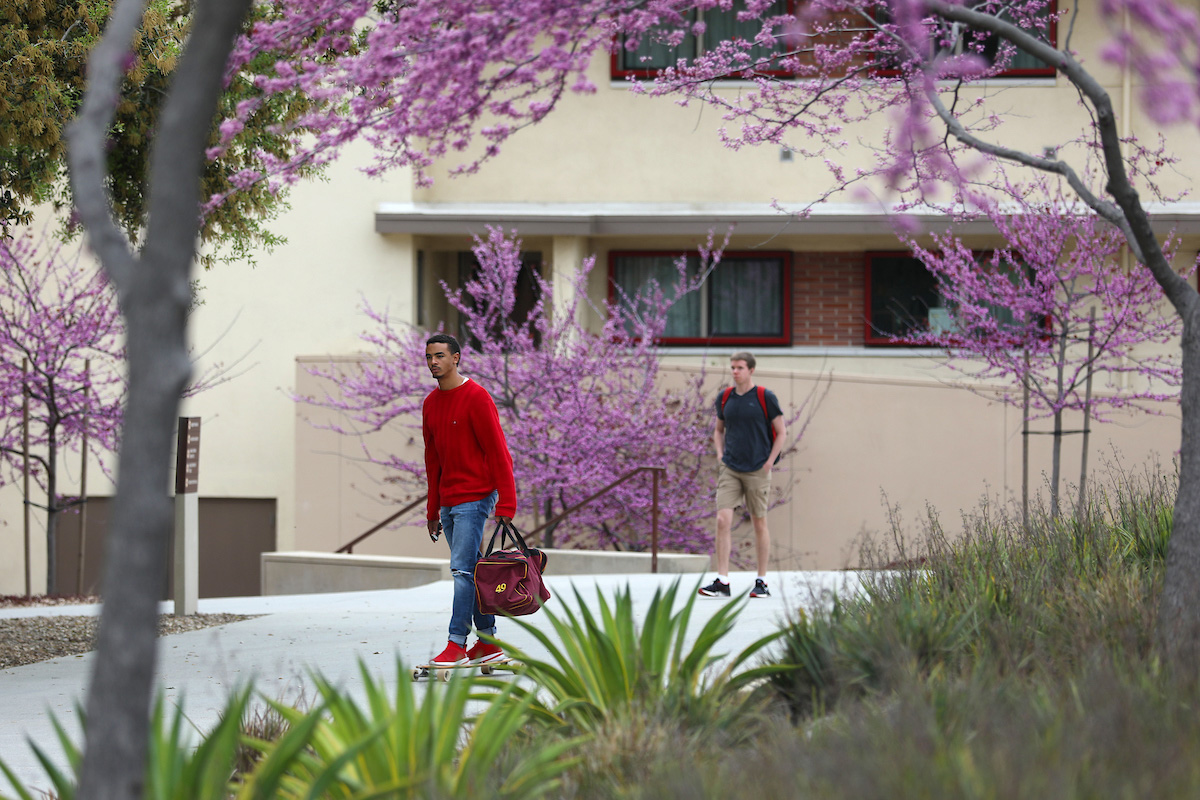 Student walking on Mid Quad.