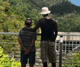 Two men looking out at the outdoors.