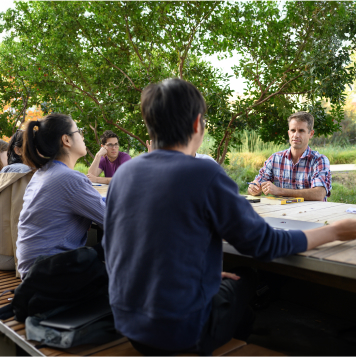 Cameron Shelton with students outside.