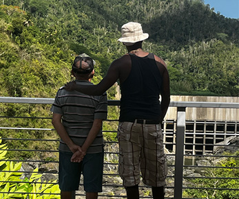 Two men looking out at the outdoors.