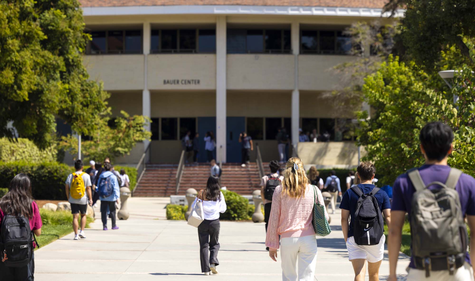 Students walking towards Bauer Center on CMC's campus.