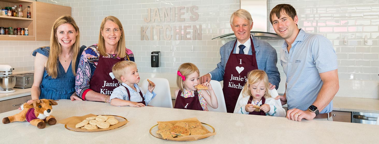 Ken Valach ’82 and Janie Valach ’82 with their family in Janie's Kitchen.