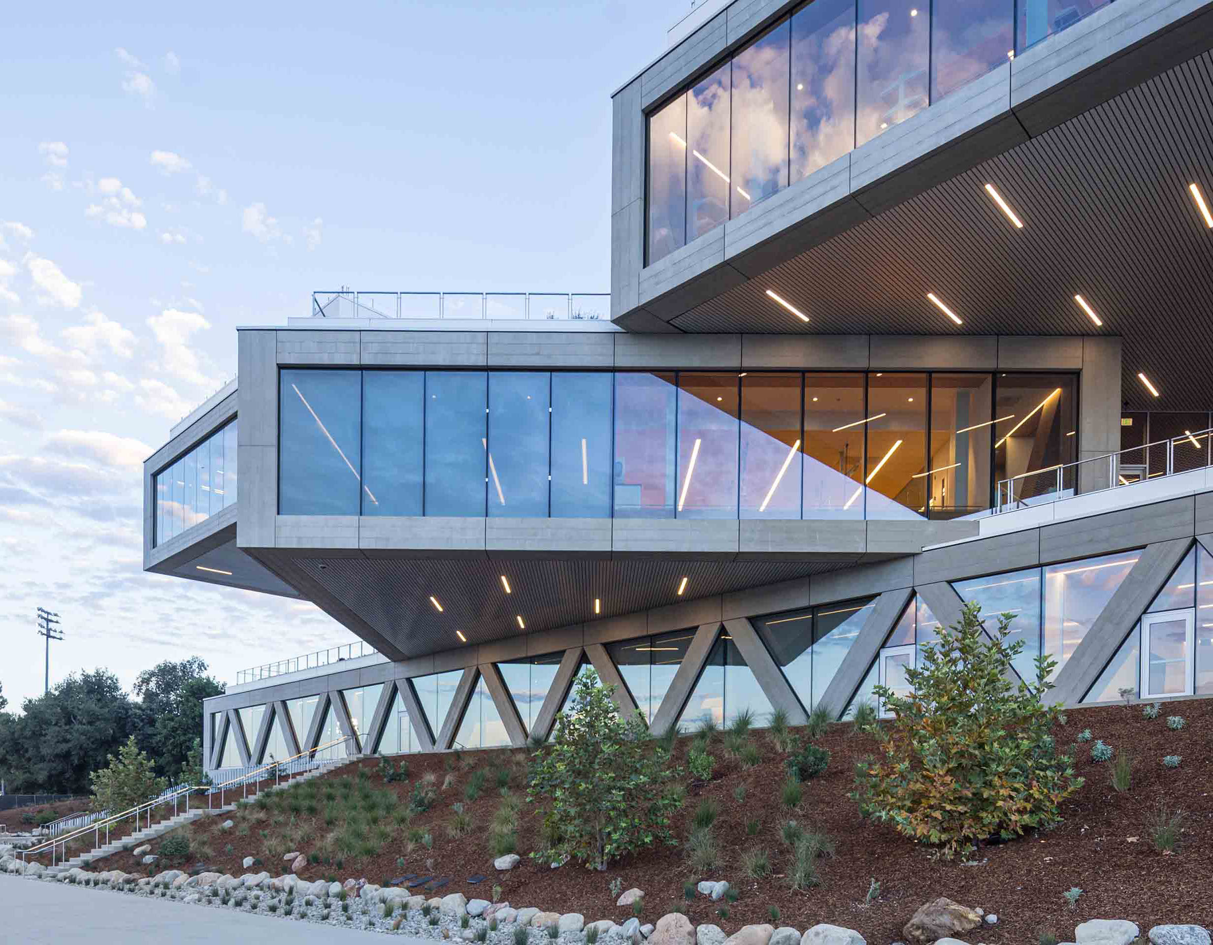The Robert Day Sciences Center at mid-afternoon, with clouds reflecting in the windows.