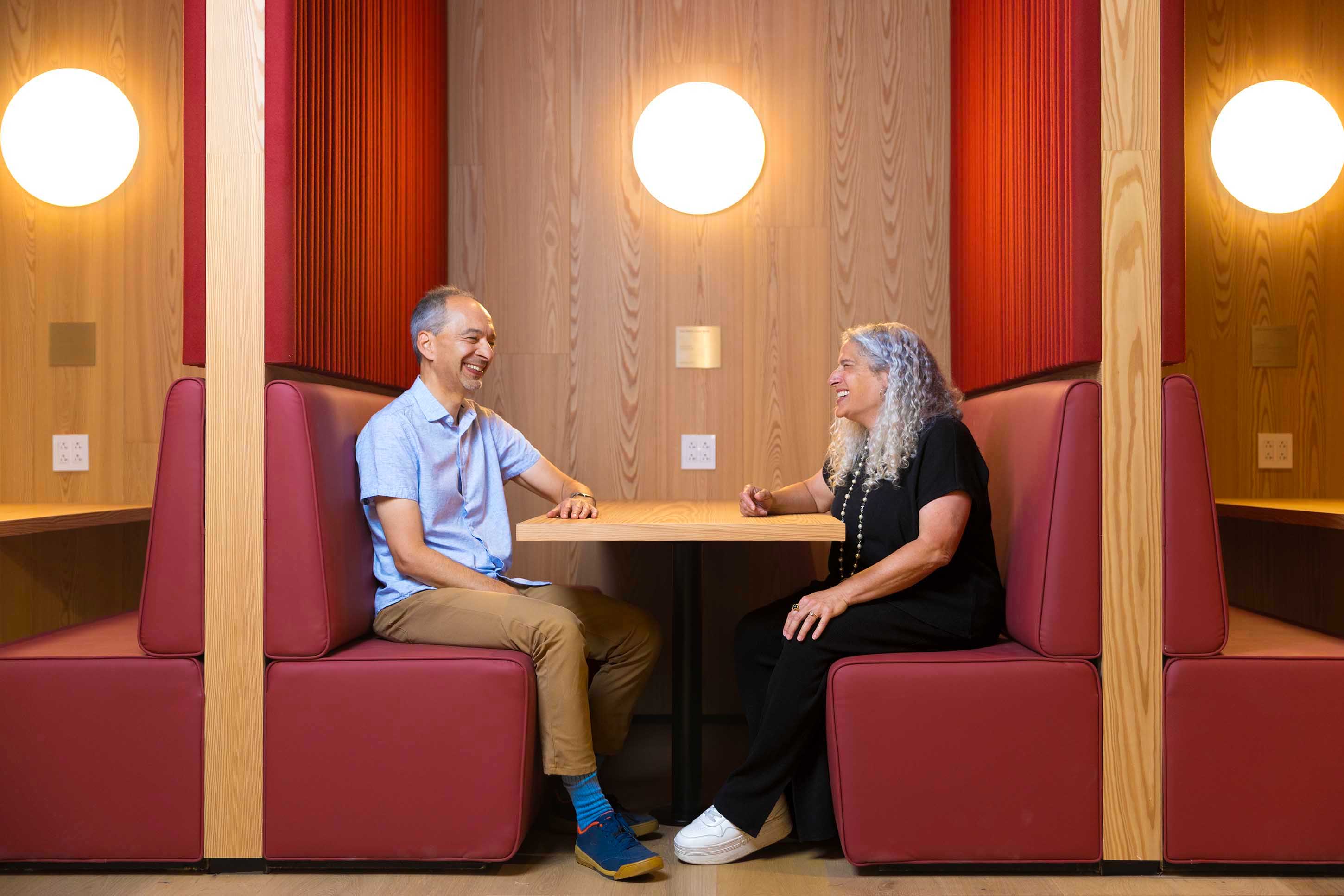 Professors Ran Libeskind-Hadas (left) and Heather Antecol, Dean of Faculty, enjoy a moment in an RDSC booth.