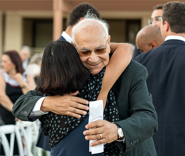 Professor Emeritus Mark Massoud P’89 hugging Priya.
