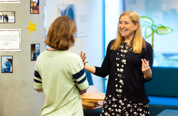 Professor Amy Kind speaking with a student.
