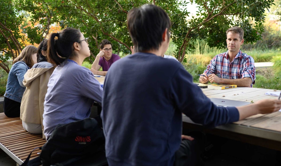 Cameron Shelton and students at a table