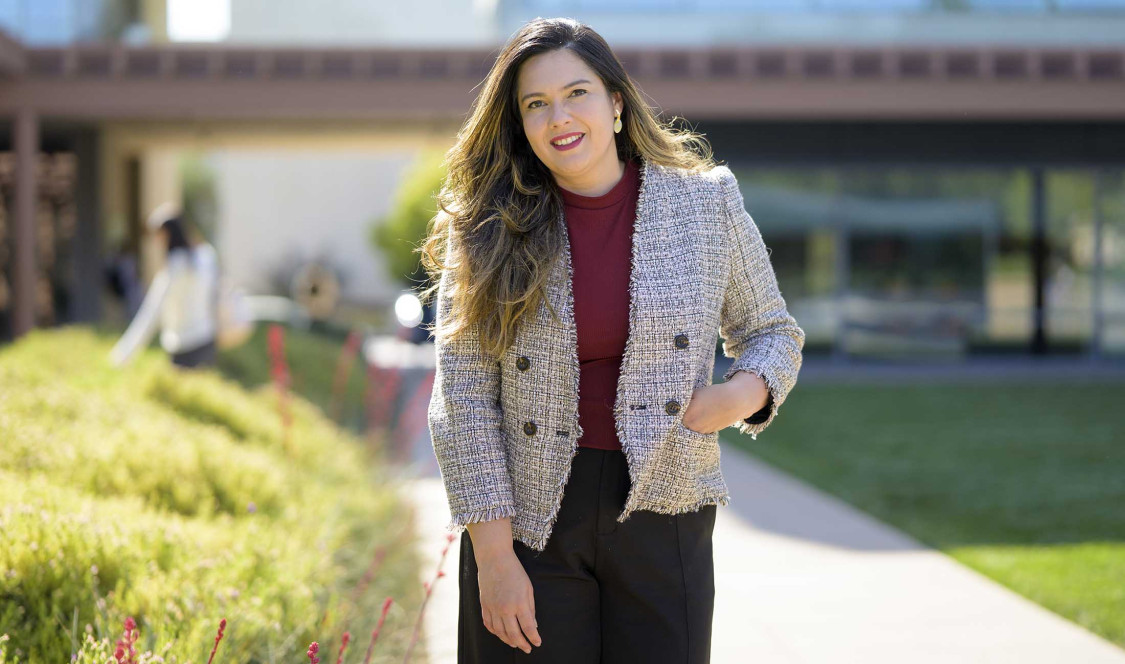 Professor Jennifer Feitosa photographed in Gann Quad on a sunny day.