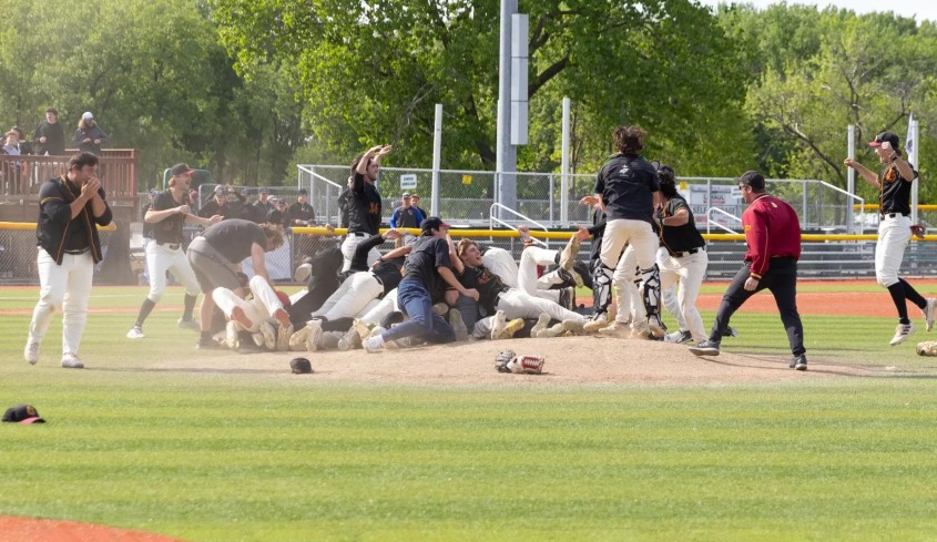 The CMS men's Baseball celebrating on the field after their victory.