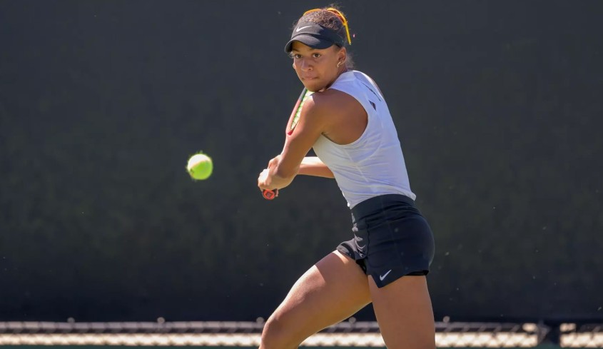 Ella Brissett '25 hitting tennis ball
