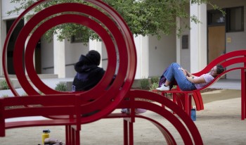 Students sit and lay down with their feet up on the newly revealed benches.