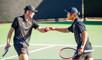 Two tennis players giving knuckle bump