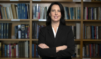Prof. Shanna Rose in front of bookcase