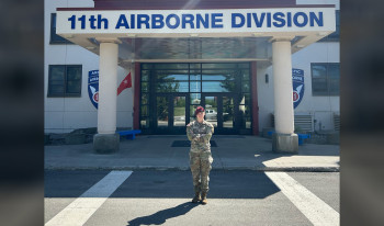Robin Peterson ’22 in front of the Airborne Division building.
