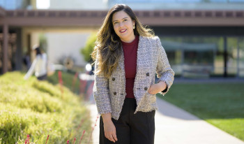 Professor Jennifer Feitosa photographed in Gann Quad on a sunny day.