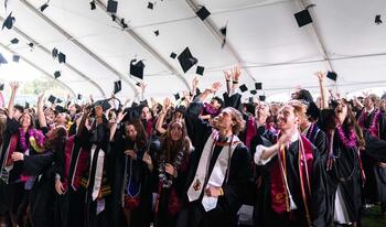 The Class of 2026 tossing their caps after the ceremony.