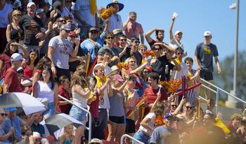 Students and crowd cheering at the football game