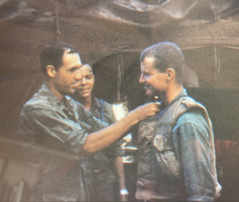 Gilbert Ferrey '64 is recognized with a military award.