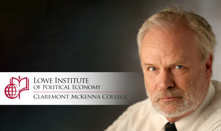 Manfred Keil, with Lowe Institute banner.