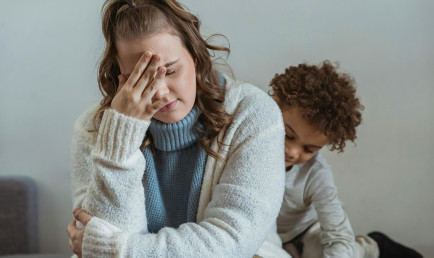 A woman holding her head in her hand in frustration.