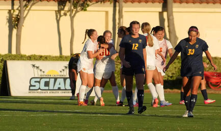CMS Women's soccer celebrating on the field