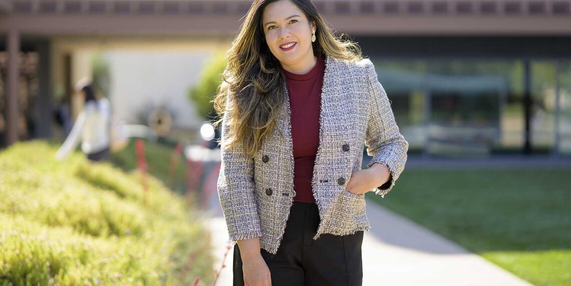 Professor Jennifer Feitosa photographed in Gann Quad on a sunny day.