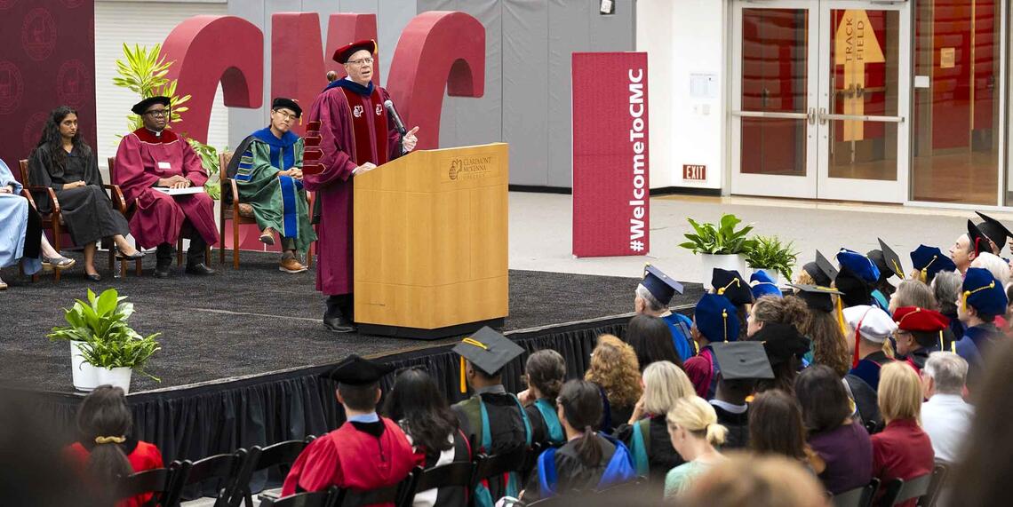 President Dudley at the podium in Roberts Pavilion during Convocation